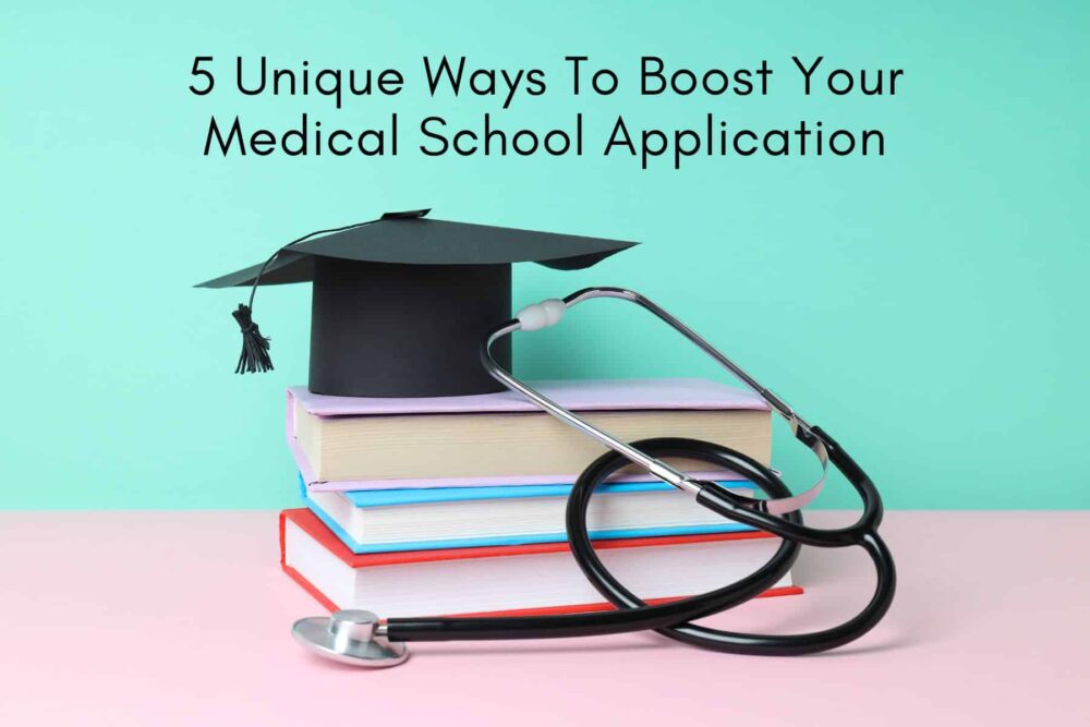 graduation cap on top of books next to stethoscope